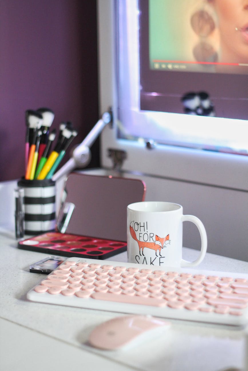 cup beside keyboard